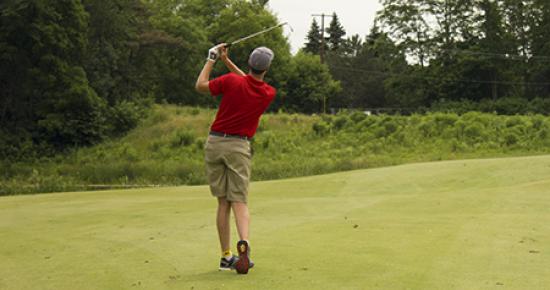 Man teeing off on Keller golf course