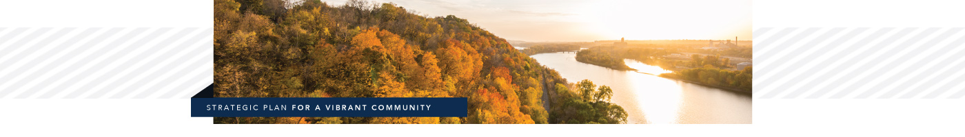 Strategic plan for a vibrant community. Includes an image of the Mississippi River and trees at sunset during autumn.