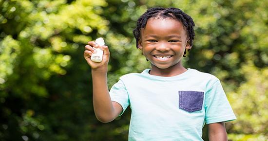 A child holding an inhaler