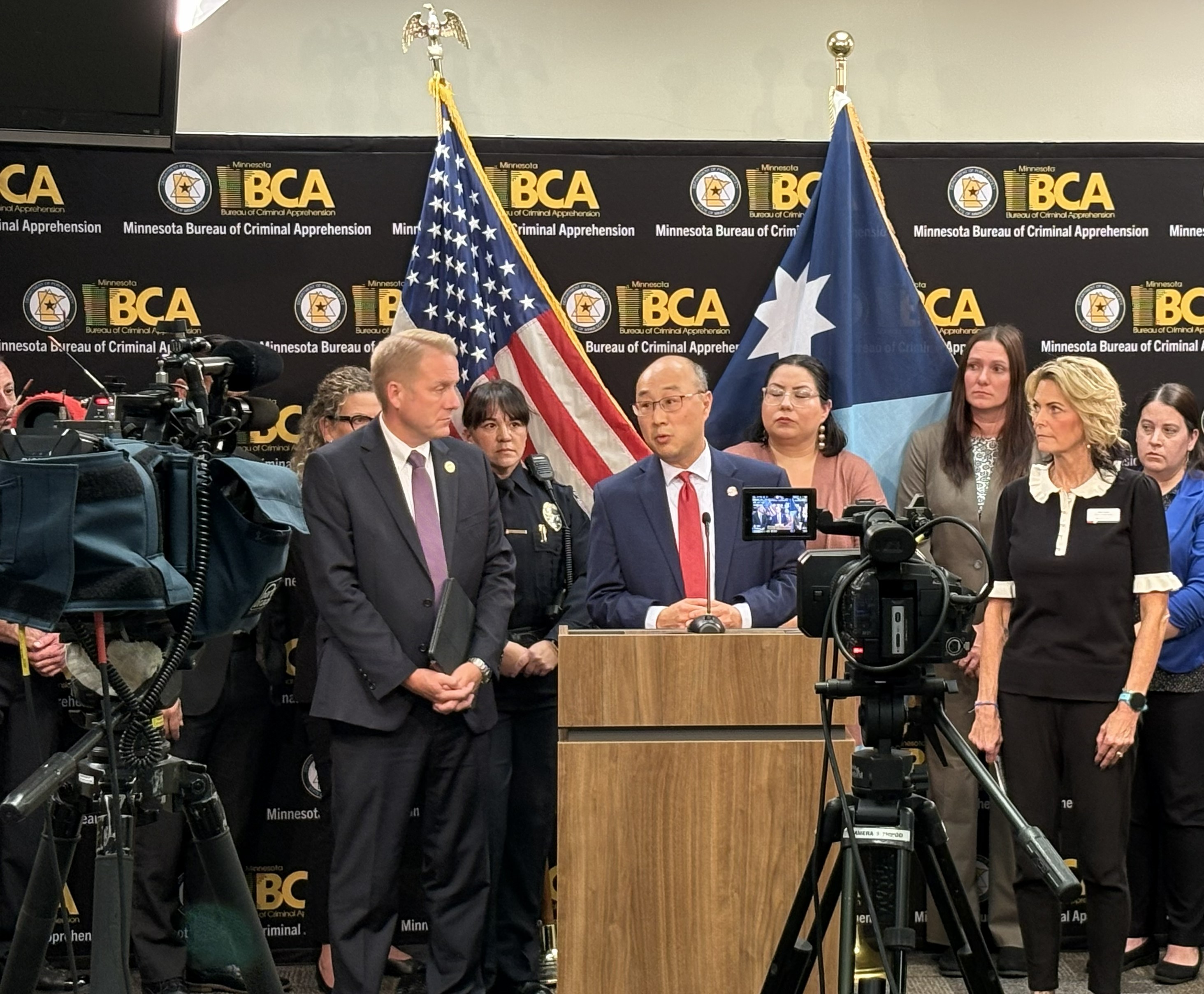John Choi speaking at podium during press conference